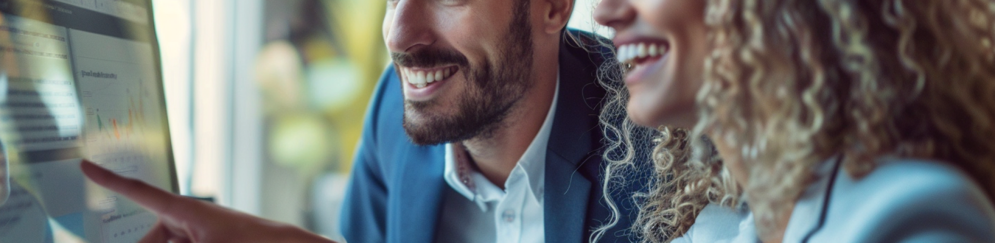 JF_Smiling_business_man_and_woman_looking_at_a_computer_scree_b5e12bf0-b962-44be-9f56-2c75330f0357_3